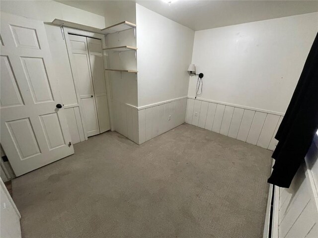 810 Broad St, Steamboat Springs, CO 80487 - unfurnished bedroom with light colored carpet, wainscoting, and a closet