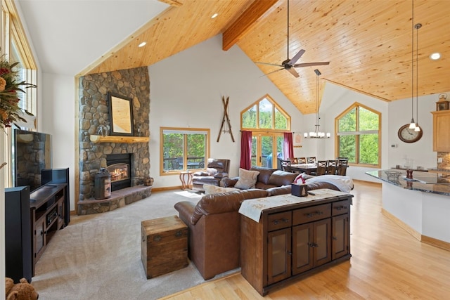 736 Wild Rose Rd, Silverthorne, CO 80498 - living area featuring high vaulted ceiling, ceiling fan, a stone fireplace, light wood-style flooring, and a wood ceiling with exposed beams