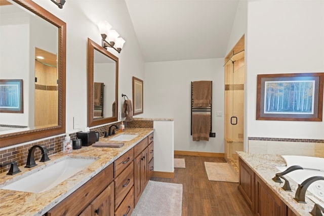 736 Wild Rose Rd, Silverthorne, CO 80498 - full bath with a stall shower, double vanity, wood finished floors, a garden tub, and vaulted ceiling