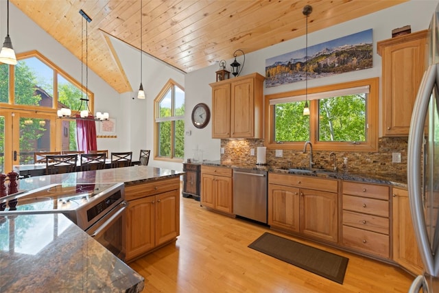 736 Wild Rose Rd, Silverthorne, CO 80498 - kitchen with appliances with stainless steel finishes, light wood-style floors, tasteful backsplash, a chandelier, and vaulted ceiling