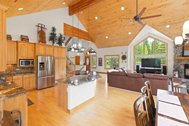 736 Wild Rose Rd, Silverthorne, CO 80498 - kitchen with appliances with stainless steel finishes, light wood-style floors, open floor plan, wood ceiling, and a fireplace