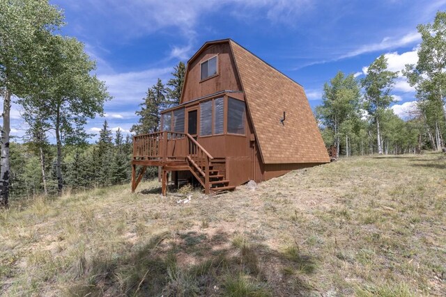 33 Sugar Loaf Ln, Jefferson, CO 80456 - back of house featuring a gambrel roof, a deck, a shingled roof, and stairway