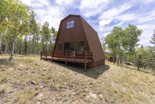 33 Sugar Loaf Ln, Jefferson, CO 80456 - rear view of property featuring a gambrel roof, a shingled roof, and a deck