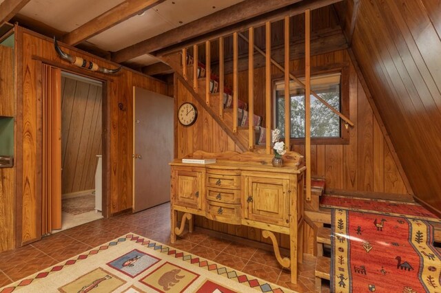 33 Sugar Loaf Ln, Jefferson, CO 80456 - interior space featuring tile patterned flooring, wood walls, and beamed ceiling