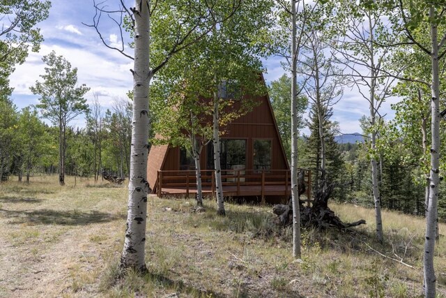 33 Sugar Loaf Ln, Jefferson, CO 80456 - exterior space with a deck and a wooded view