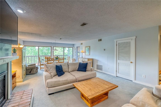 2510 Ryan Gulch Rd Unit 2512, Silverthorne, CO 80498 - living area featuring light carpet, a textured ceiling, and a brick fireplace