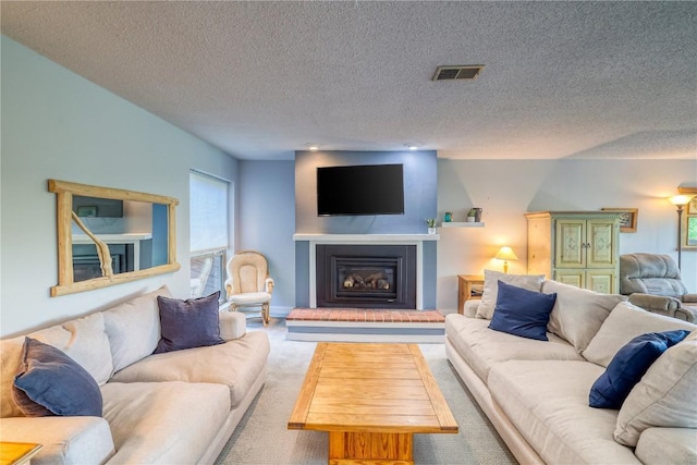 2510 Ryan Gulch Rd Unit 2512, Silverthorne, CO 80498 - living area featuring carpet, a textured ceiling, and a glass covered fireplace