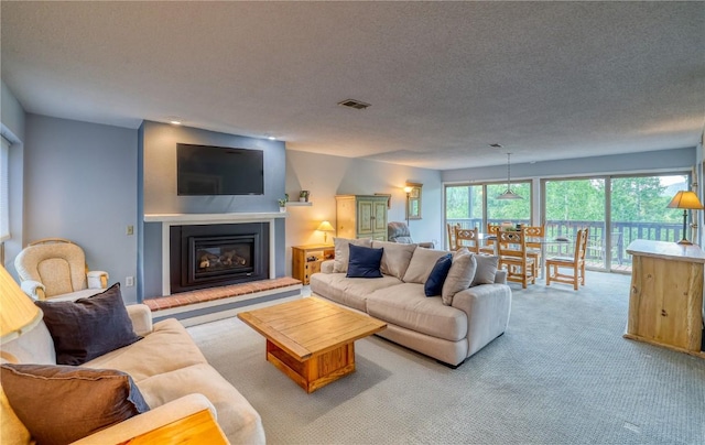 2510 Ryan Gulch Rd Unit 2512, Silverthorne, CO 80498 - living area featuring light colored carpet, a glass covered fireplace, and a textured ceiling