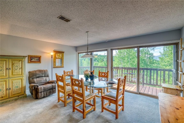 2510 Ryan Gulch Rd Unit 2512, Silverthorne, CO 80498 - dining space with light carpet, plenty of natural light, and a textured ceiling