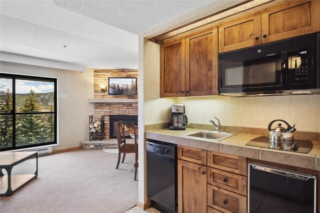 640 Village Rd Unit 4423, Breckenridge, CO 80424 - kitchen with a sink, light colored carpet, brown cabinets, light countertops, and black appliances