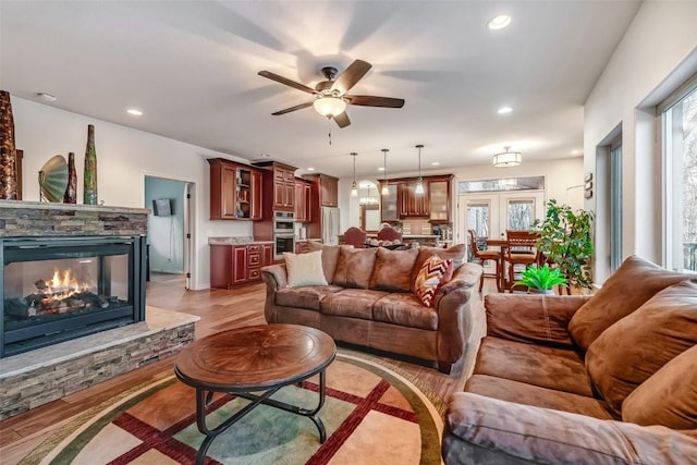 53 Anhinga Rd, Como, CO 80432 - living room with a fireplace, a ceiling fan, light wood-style floors, and plenty of natural light