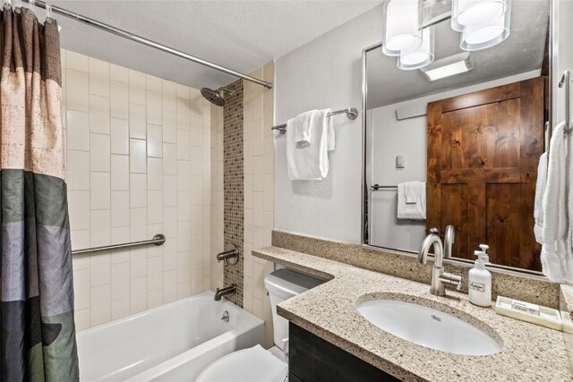 2700 Village Dr Unit C107, Steamboat Springs, CO 80487 - full bathroom with shower / bath combo with shower curtain, vanity, toilet, and a textured ceiling