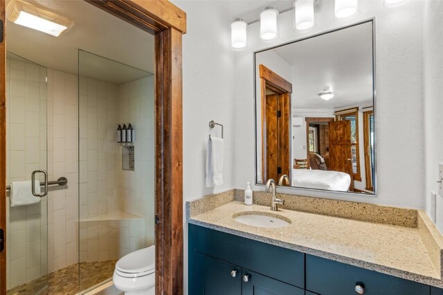 2700 Village Dr Unit C107, Steamboat Springs, CO 80487 - full bathroom with vanity, a stall shower, toilet, and ensuite bath