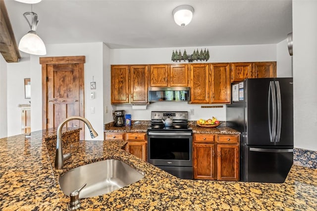 2700 Village Dr Unit C107, Steamboat Springs, CO 80487 - kitchen featuring freestanding refrigerator, electric range, a sink, dark stone counters, and pendant lighting