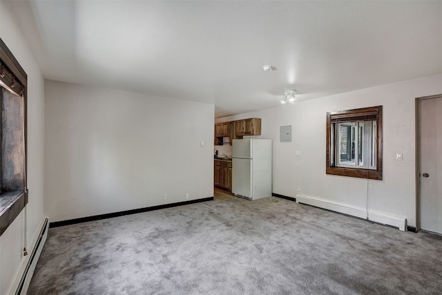 214 S Harris St Unit 206, Breckenridge, CO 80424 - unfurnished living room with baseboard heating, a baseboard heating unit, light colored carpet, electric panel, and baseboards