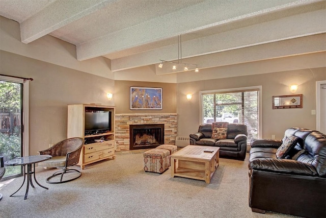 living room featuring carpet, beam ceiling, plenty of natural light, and a fireplace