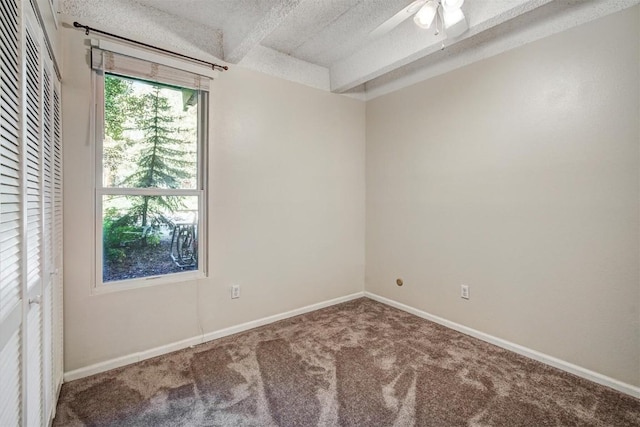 empty room with baseboards, carpet floors, ceiling fan, and a textured ceiling