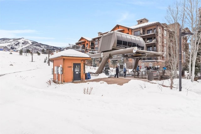 snow covered property featuring a mountain view