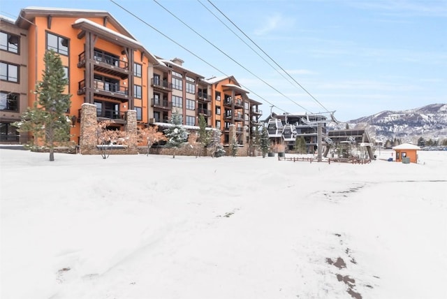 snow covered building with a mountain view