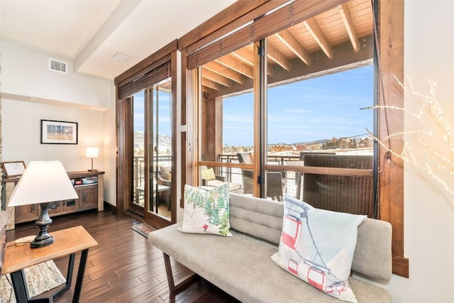 living area with wood finished floors and visible vents