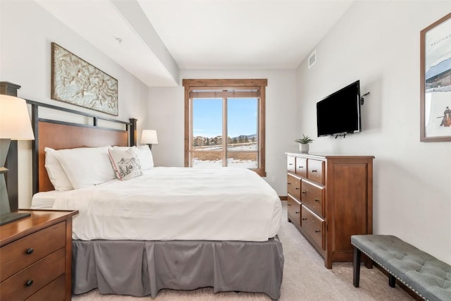 bedroom with visible vents, access to outside, and light colored carpet