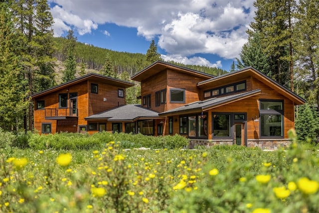 89 Wilderness Dr, Breckenridge, CO 80424 - rear view of house with a balcony and a wooded view