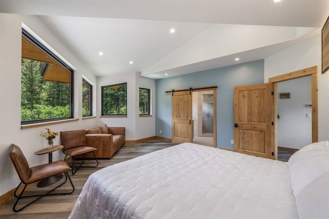 89 Wilderness Dr, Breckenridge, CO 80424 - bedroom with wood finished floors, vaulted ceiling, a barn door, and recessed lighting