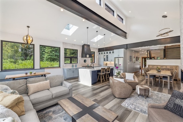 89 Wilderness Dr, Breckenridge, CO 80424 - living room featuring light wood-style floors, beamed ceiling, high vaulted ceiling, a skylight, and recessed lighting