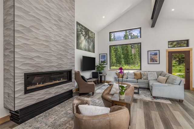 89 Wilderness Dr, Breckenridge, CO 80424 - living room featuring wood finished floors, a glass covered fireplace, high vaulted ceiling, beamed ceiling, and recessed lighting