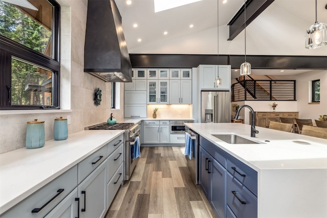 89 Wilderness Dr, Breckenridge, CO 80424 - kitchen with stainless steel appliances, ventilation hood, light wood-style flooring, decorative backsplash, and recessed lighting