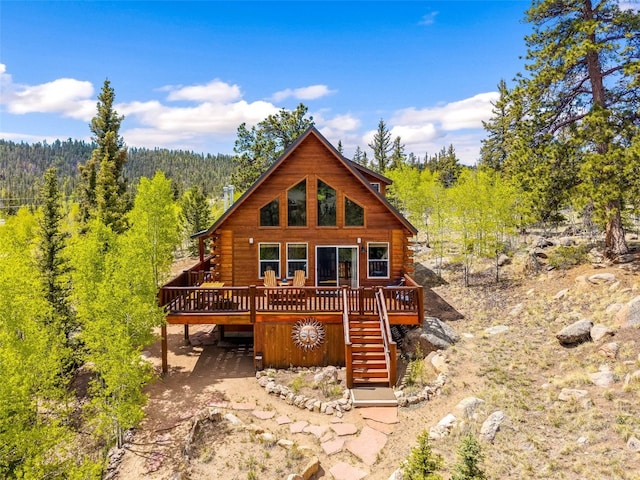 146 Atoka Dr, Como, CO 80432 - view of front of property with a deck, stairway, a forest view, and log siding