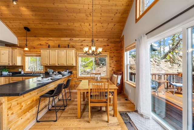 146 Atoka Dr, Como, CO 80432 - dining room featuring plenty of natural light, light wood-type flooring, wooden ceiling, wooden walls, and high vaulted ceiling