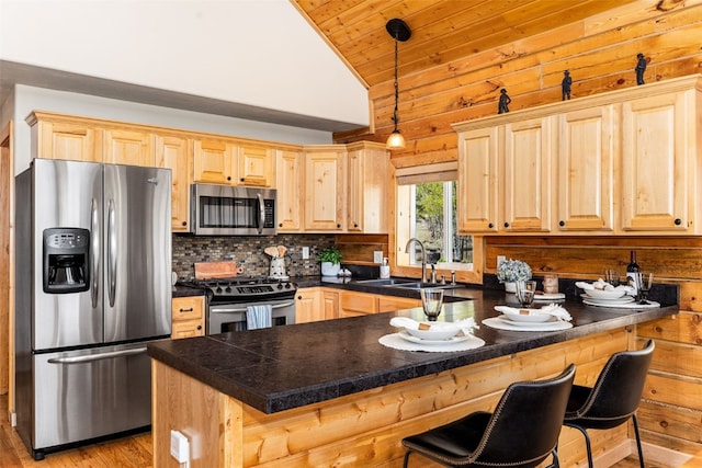 146 Atoka Dr, Como, CO 80432 - kitchen featuring stainless steel appliances, light brown cabinets, a peninsula, a sink, and tile countertops