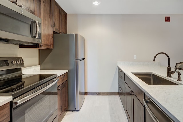 1001 Grandview Dr Unit 22, Breckenridge, CO 80424 - kitchen featuring stainless steel appliances, a sink, baseboards, dark brown cabinets, and recessed lighting