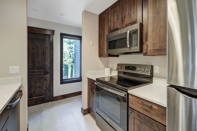 1001 Grandview Dr Unit 22, Breckenridge, CO 80424 - kitchen featuring stainless steel appliances, light countertops, baseboards, and dark brown cabinets