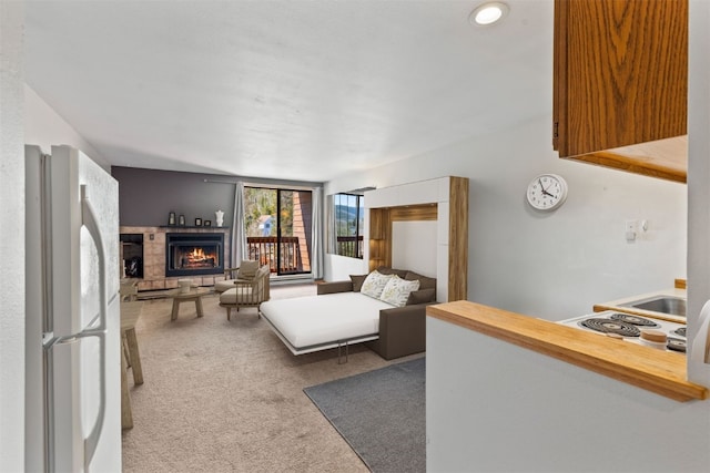 carpeted living area featuring a lit fireplace