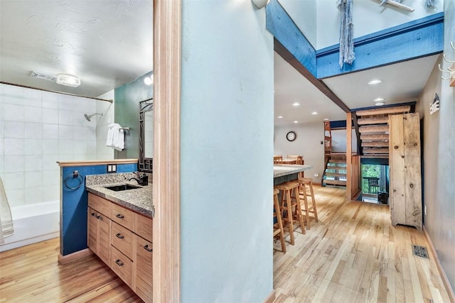 2615 Apres Ski Way Unit B1, Steamboat Springs, CO 80487 - full bath featuring wood finished floors, vanity, and shower / bath combination