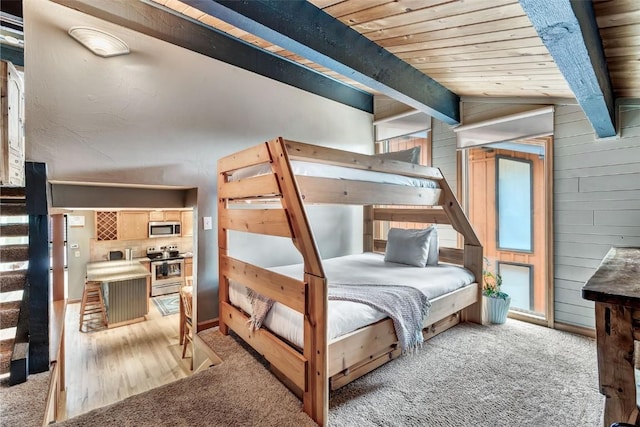 2615 Apres Ski Way Unit B1, Steamboat Springs, CO 80487 - bedroom with light colored carpet, wooden ceiling, and wood walls