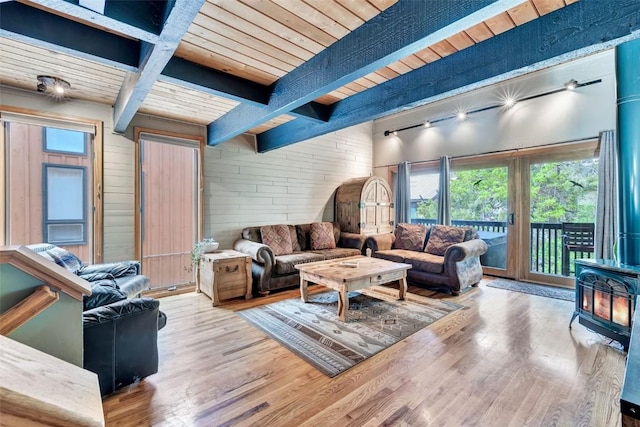 2615 Apres Ski Way Unit B1, Steamboat Springs, CO 80487 - living room with a wood stove, wood ceiling with exposed beams, wood walls, and wood finished floors