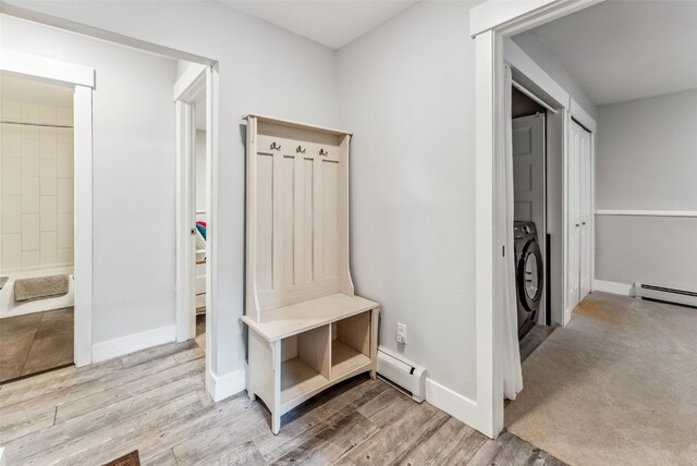 mudroom featuring washer / dryer, light wood-type flooring, and a baseboard heating unit