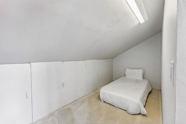 carpeted bedroom featuring vaulted ceiling