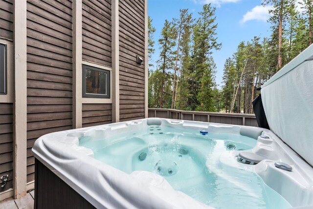 wooden terrace featuring a hot tub