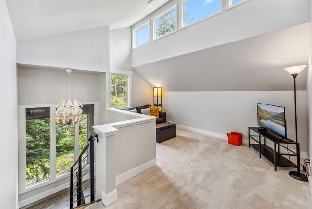 sitting room with a notable chandelier and light colored carpet