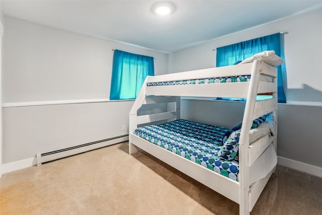 bedroom featuring carpet flooring and a baseboard heating unit