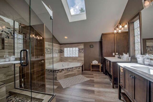 185 S Fuller Placer Rd, Breckenridge, CO 80424 - bathroom with lofted ceiling, two vanities, a bath, a stall shower, and a skylight