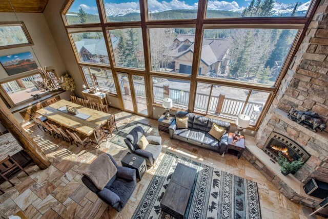 185 S Fuller Placer Rd, Breckenridge, CO 80424 - living area featuring a high ceiling and a stone fireplace