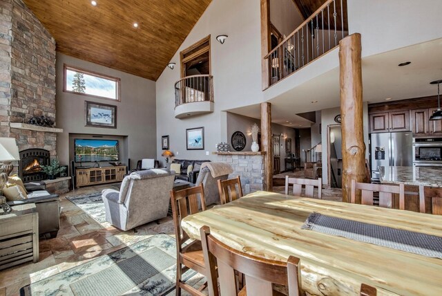 185 S Fuller Placer Rd, Breckenridge, CO 80424 - dining room featuring high vaulted ceiling, a stone fireplace, ornate columns, wood ceiling, and recessed lighting