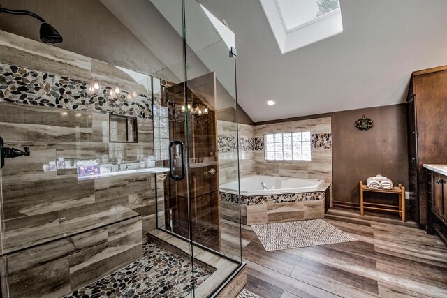 185 S Fuller Placer Rd, Breckenridge, CO 80424 - full bath featuring lofted ceiling, a bath, a stall shower, vanity, and wood finished floors