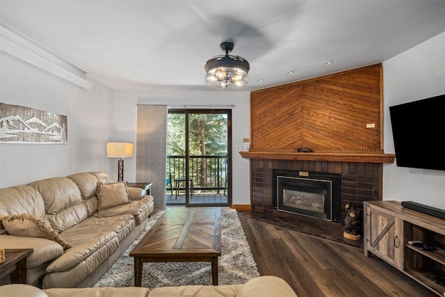 living room with a fireplace with flush hearth, wood finished floors, and recessed lighting