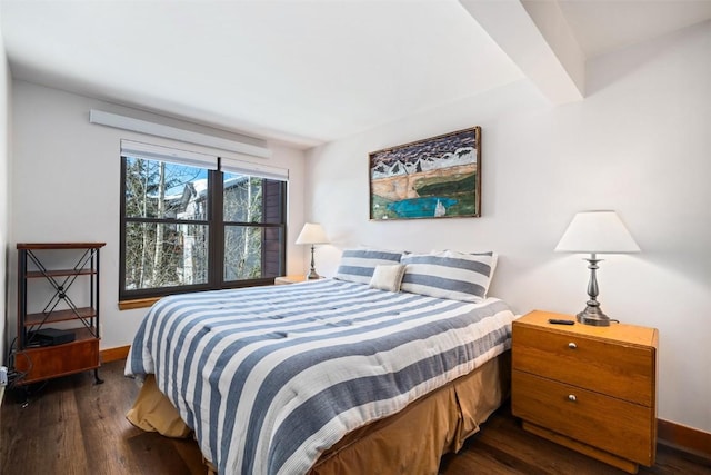 bedroom with baseboards and dark wood finished floors